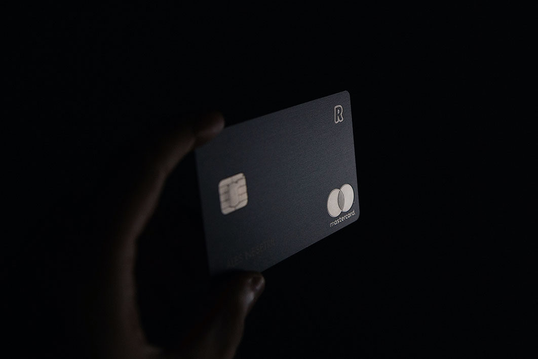 person holding black credit card